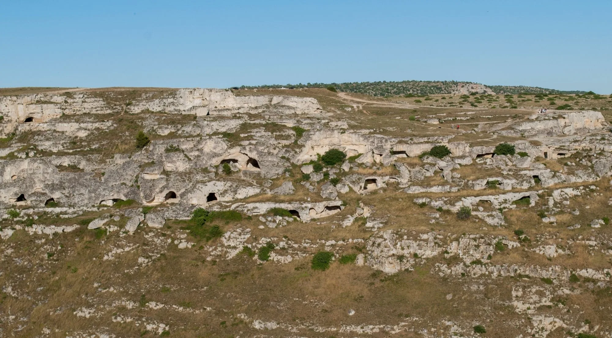 The Murgia plateau opposite Matera, its rocky slope dotted with cave openings
