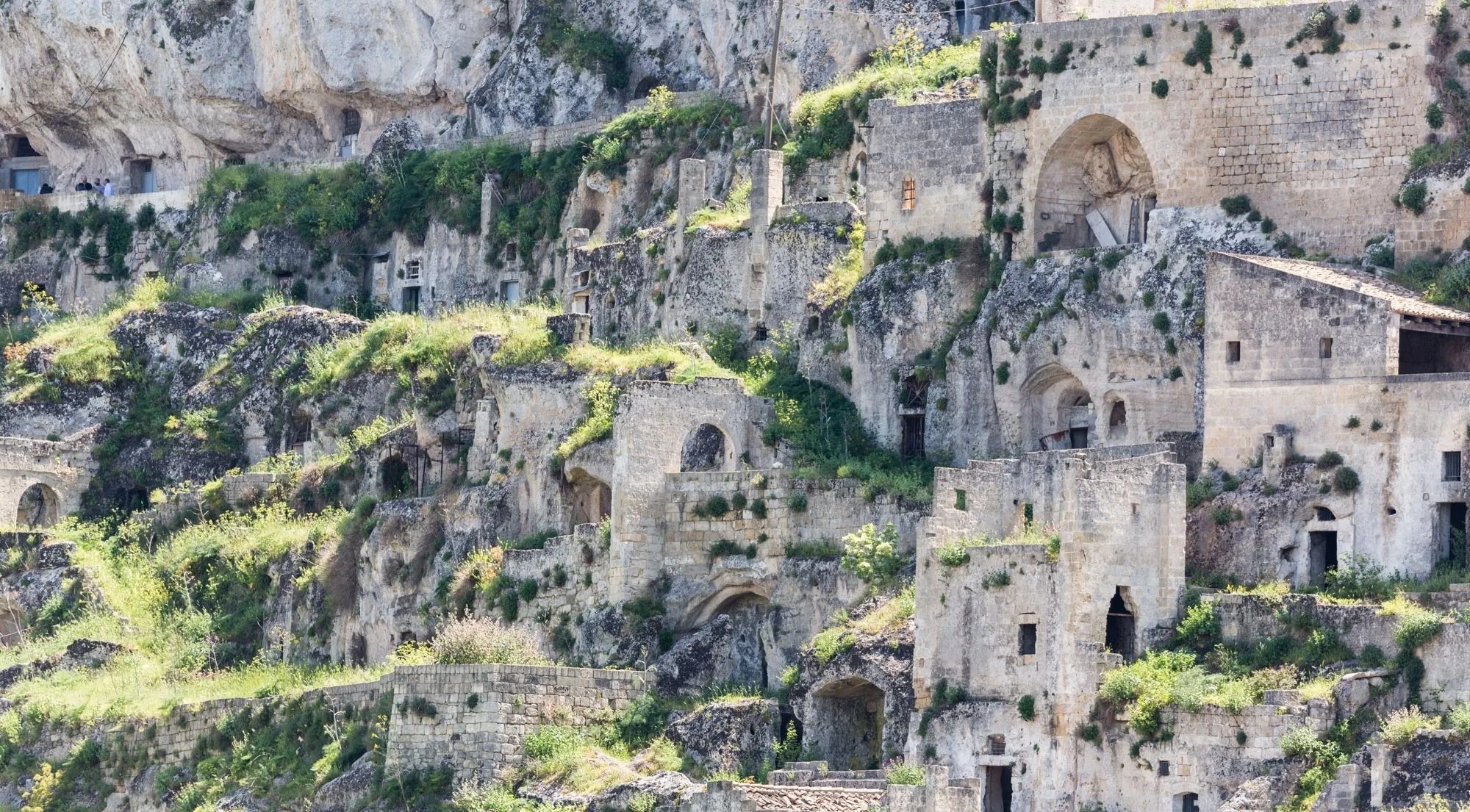 Rock-cut dwellings and stone facades built into the limestone cliff of the Sassi