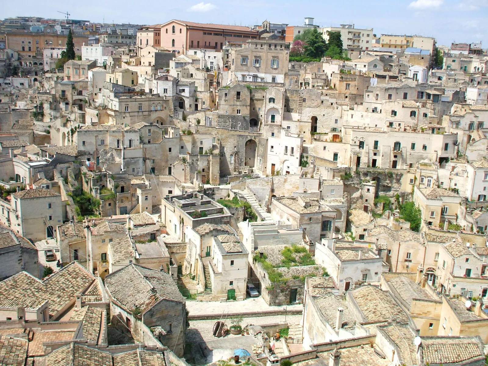 Looking down on the stacked pale stone houses and tiled roofs of the Sassi di Matera.